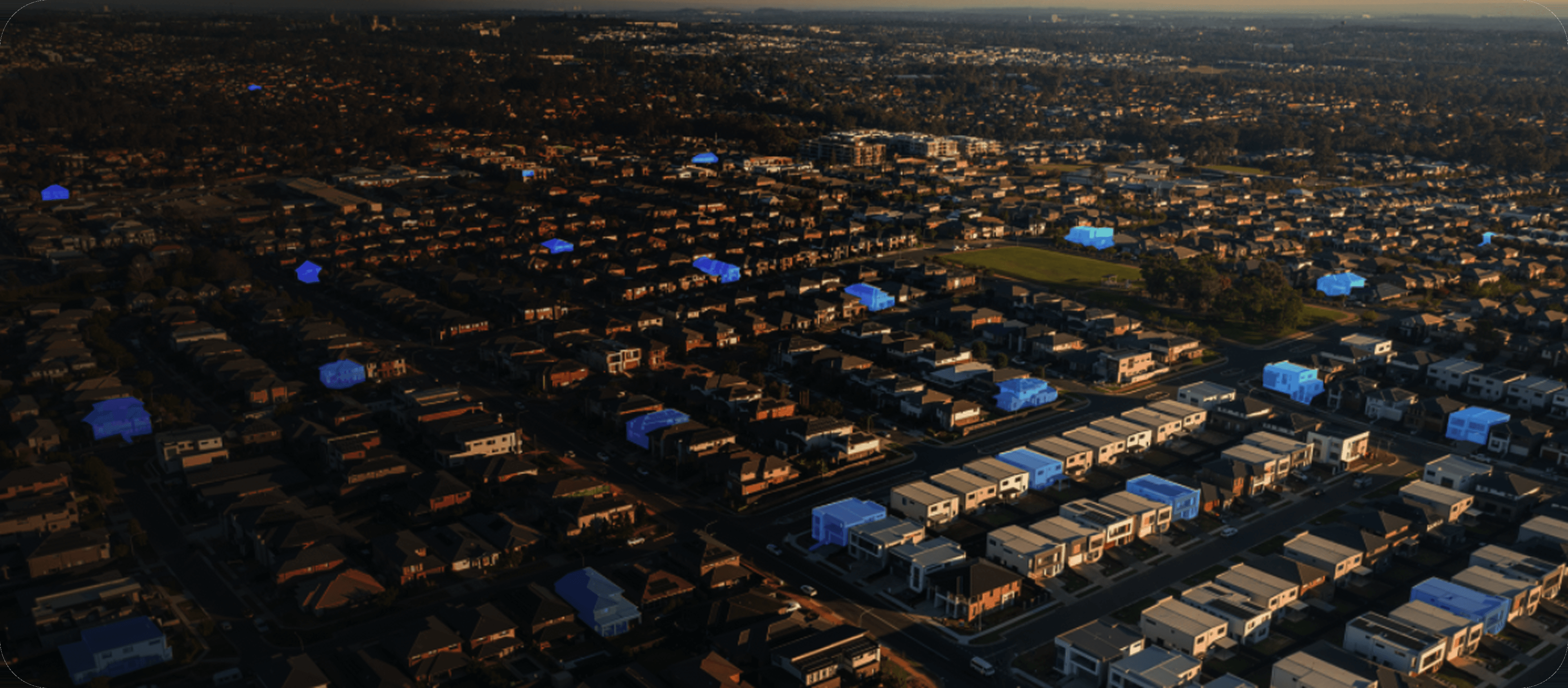 Aerial view of a suburban area with selected houses highlighted in blue, illustrating Selas® hot leads across an agent’s local market.